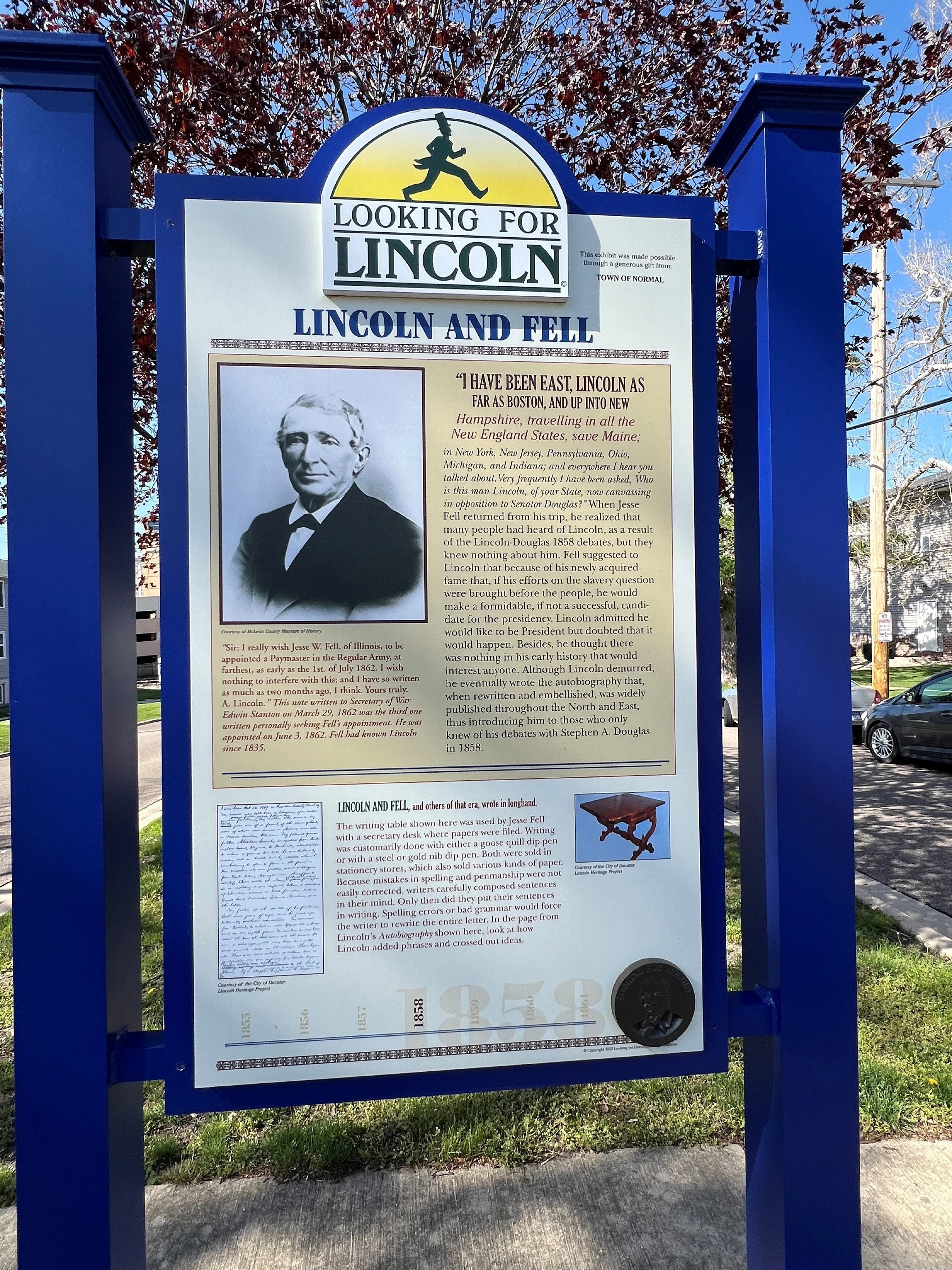 Historical marker sign with blue frame titled 