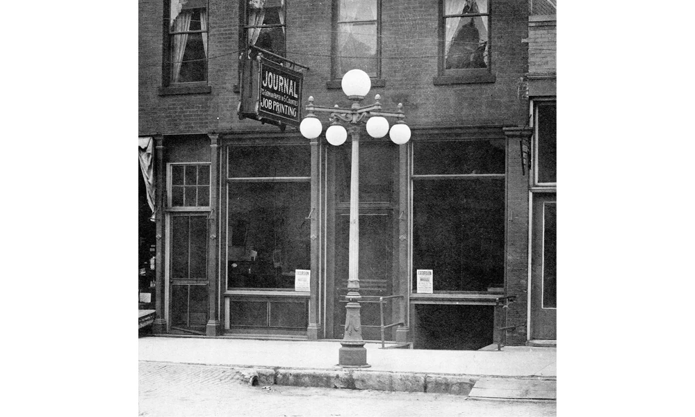 A brick building with a streetlight in front.